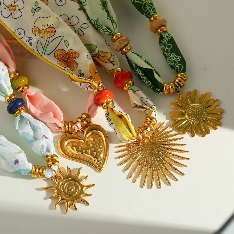 Shop the Scarf Collection at Layers.Store – bold statement necklaces blending silky fabric wraps with gold charms. From celestial to coastal, each piece is made to turn heads and layer beautifully.