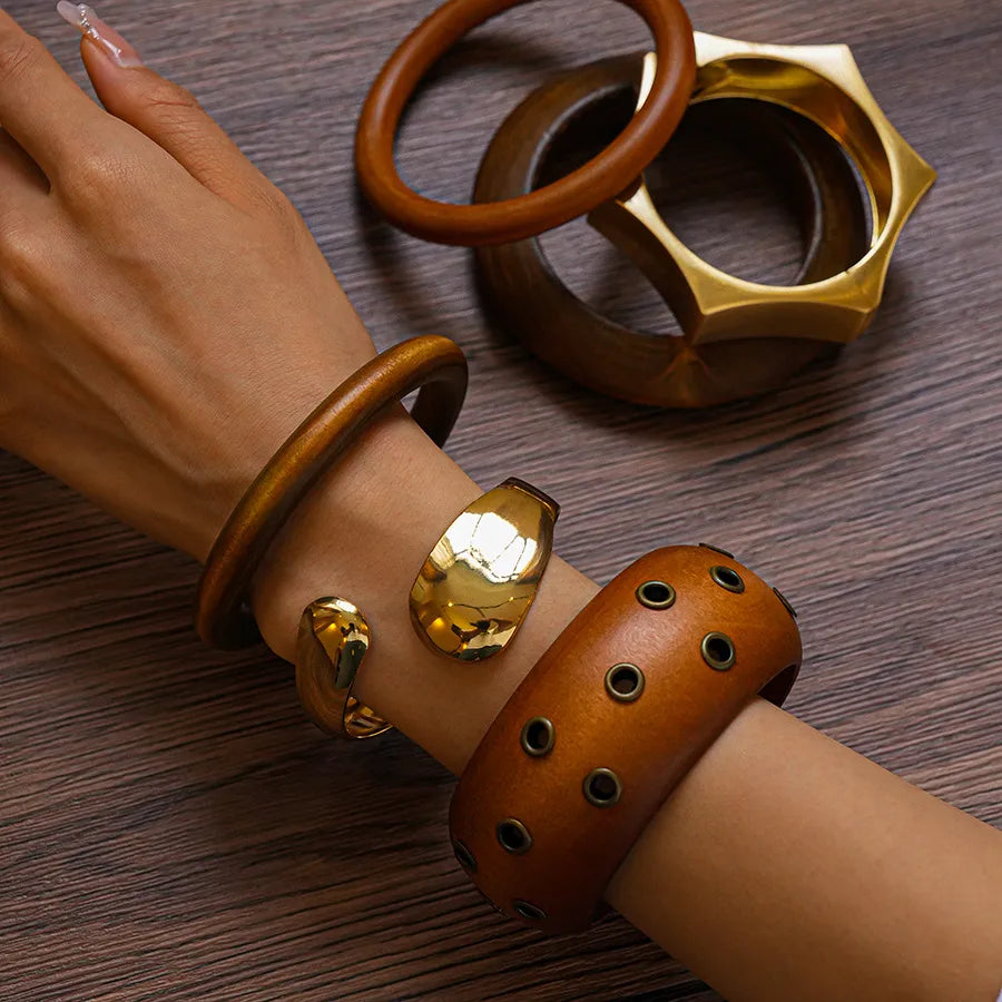 Polished gold dome bangle, wide oval profile