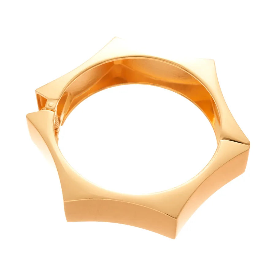 Black resin bangle with gold star studs, statement width