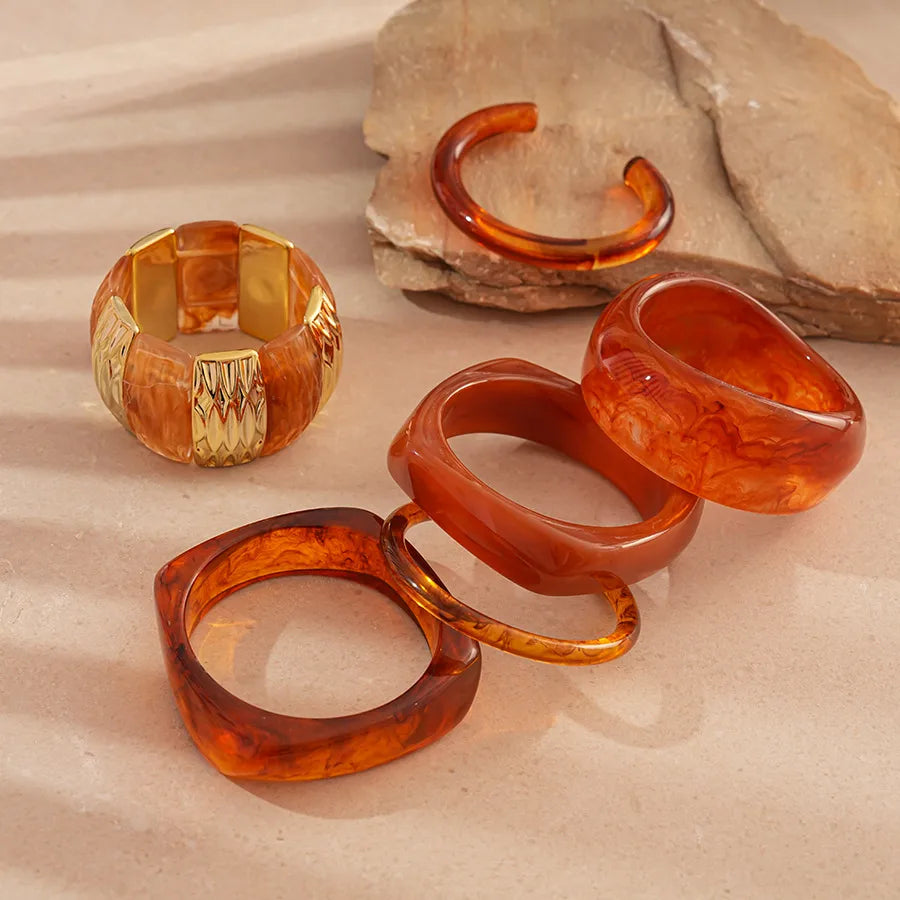 Translucent amber round dome resin bangle with marbled swirls