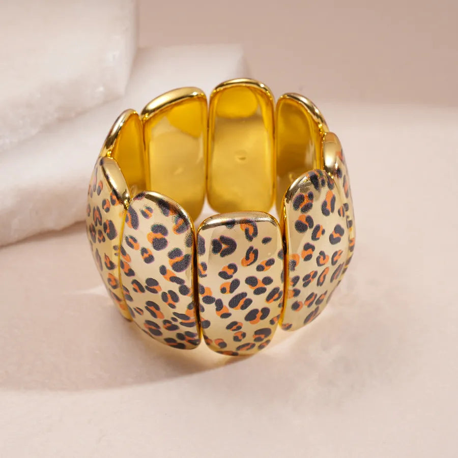 Animal-print stretch bangle with gold-tone finish for bold wrist layers