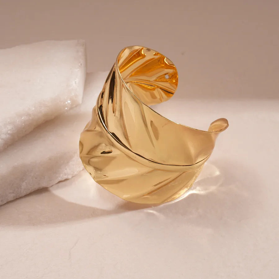 Leopard enamel oval stretch bangle with gold-tone edges stacked on wrist