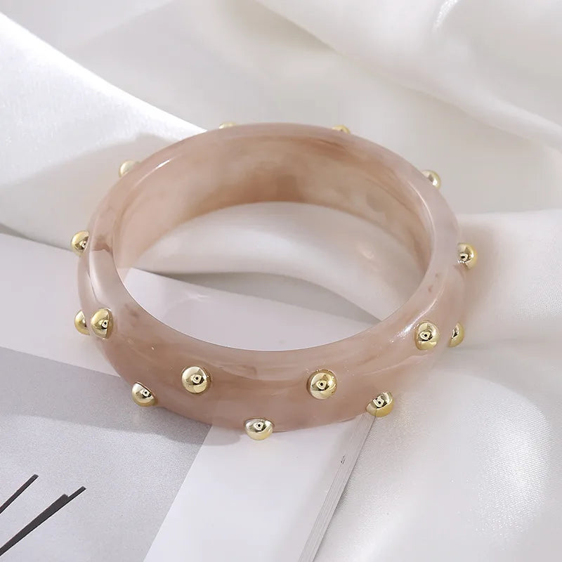 Set of three bangles: two polished gold-tone