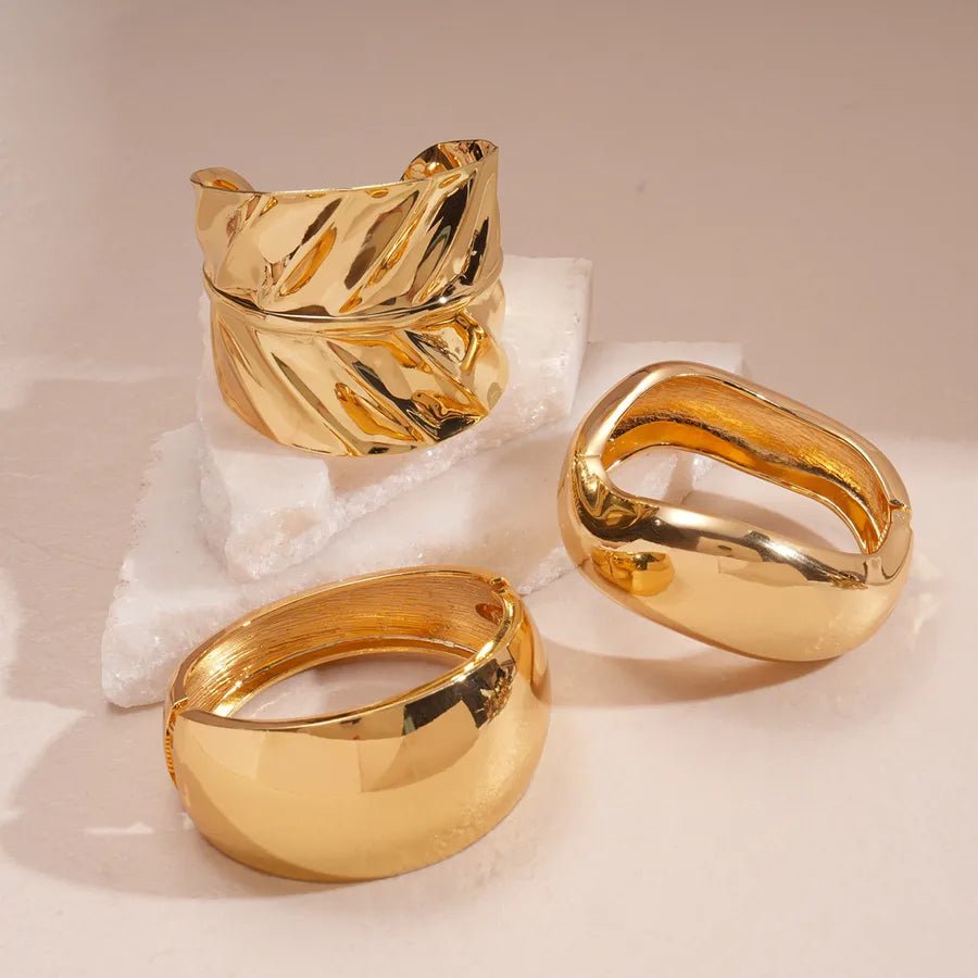 Leopard enamel oval stretch bangle with gold-tone edges stacked on wrist