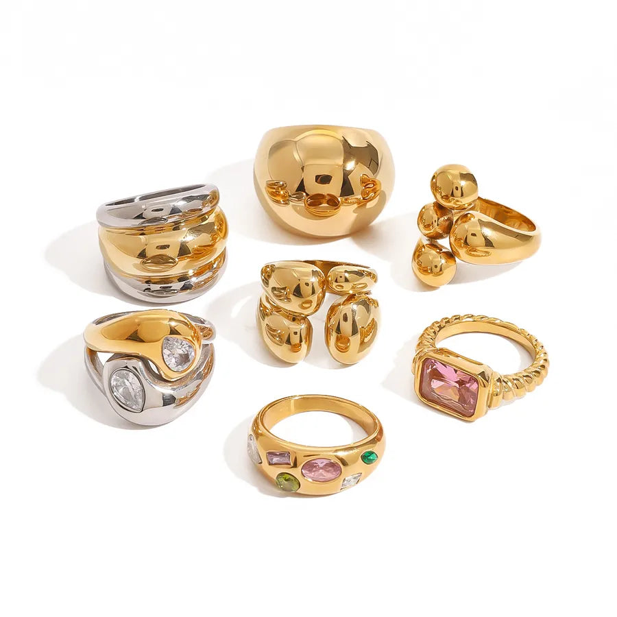 Gold and silver chunky sculptural rings stacked on hands, featuring metallic finish from The Layers jewellery collection.