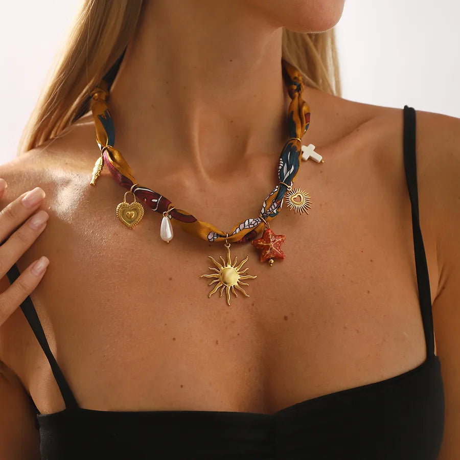 Charm & Chroma Necklace – Multicolour scarf wrap with gold charms including sun, heart, pearl and cross – Layers UK jewellery store