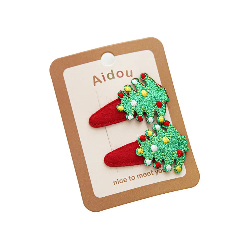 Festive Christmas-themed glitter hair clips featuring Santa, reindeer, Christmas trees, and gingerbread designs — perfect holiday accessories from The Layers.
