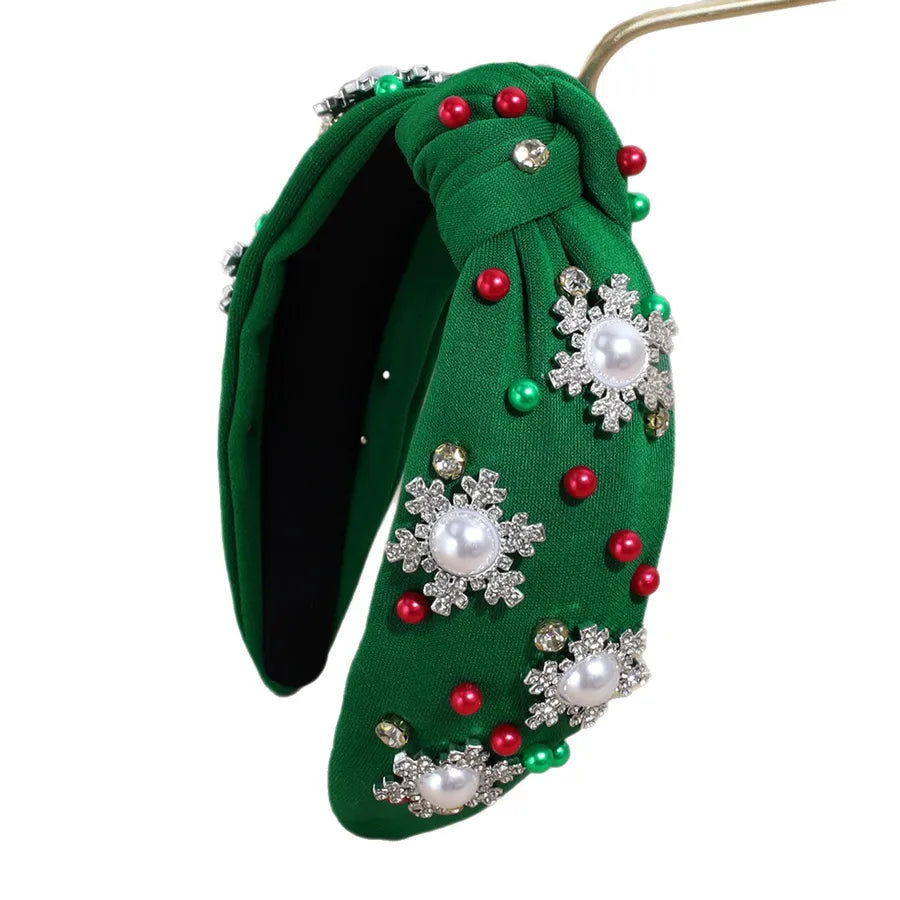 Pearl and rhinestone embellished Christmas headbands in black, red, green, and white — festive holiday hair accessories from The Layers.