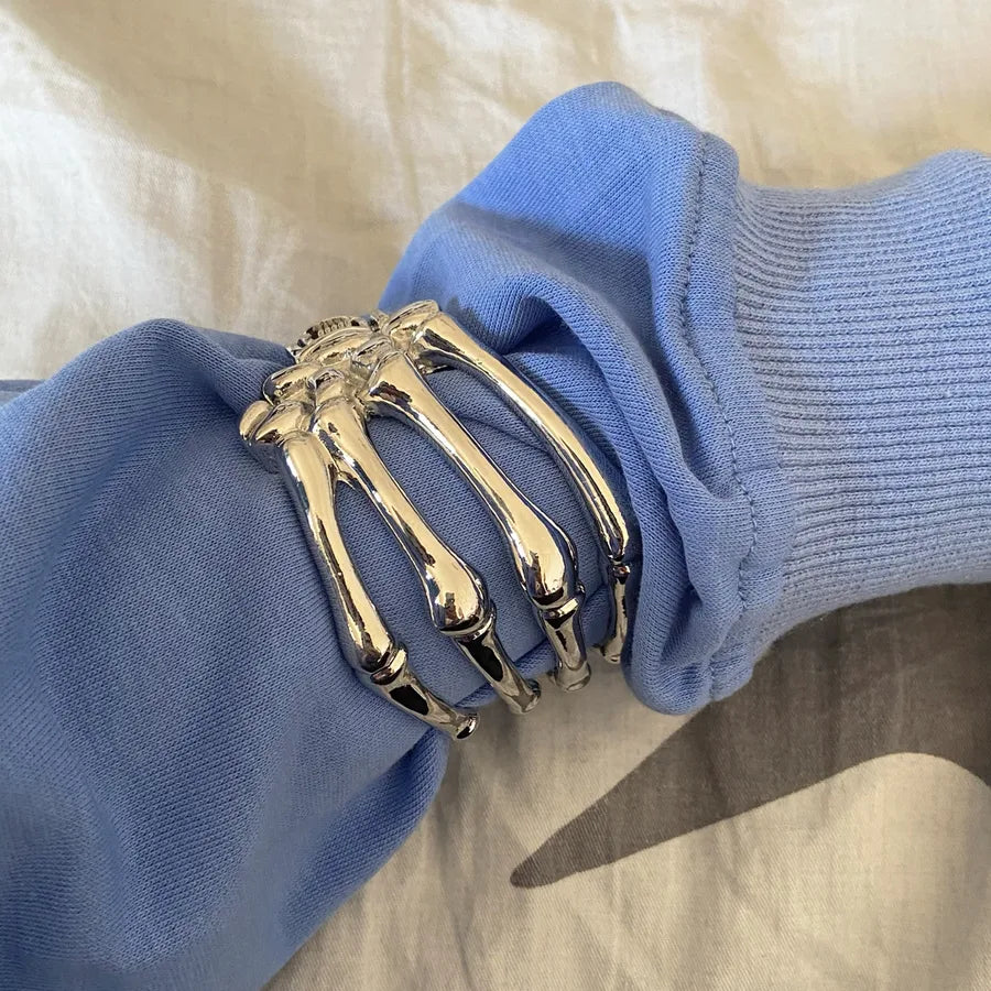 Grip Reaper skeleton hand bangle – silver alloy cuff in skull shape – unisex Halloween bracelet at Layers Store UK