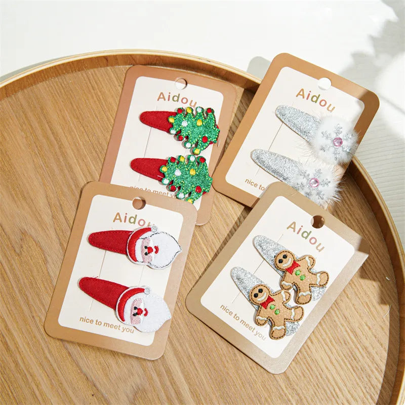 Festive Christmas-themed glitter hair clips featuring Santa, reindeer, Christmas trees, and gingerbread designs — perfect holiday accessories from The Layers.