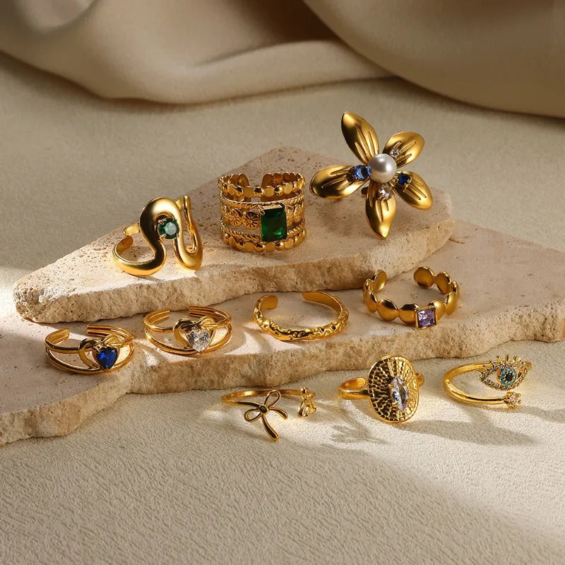 Gold-plated adjustable ring set featuring gemstone, floral, and textured designs from The Layers jewellery collection.
