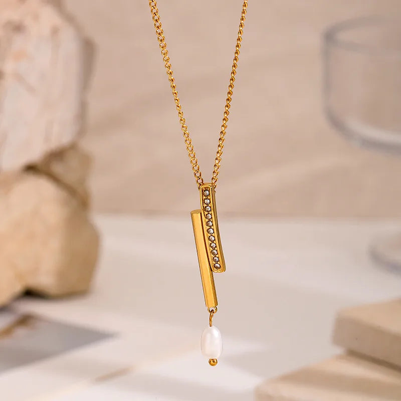 Set of gold-plated charm necklaces featuring moon, bow, gemstone, and enamel fish pendants — elegant handcrafted jewelry from The Layers.