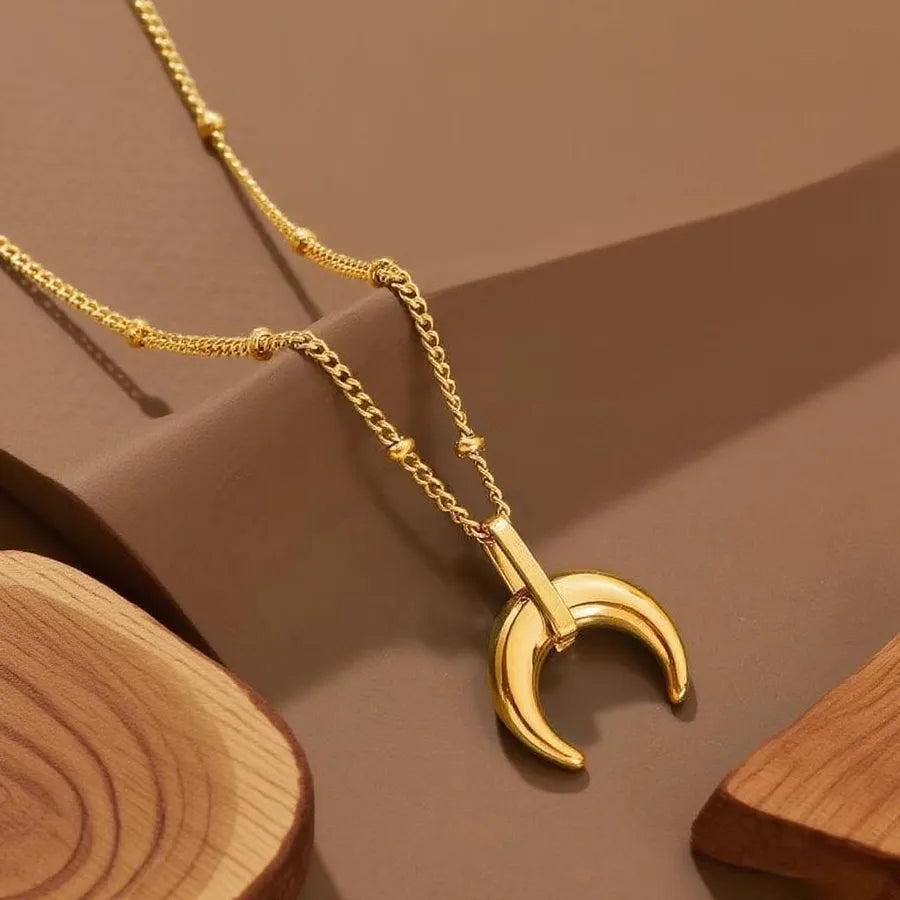 Gold-plated layered necklace with crescent moon pendant on beaded chain — minimalist celestial jewelry from The Layers.