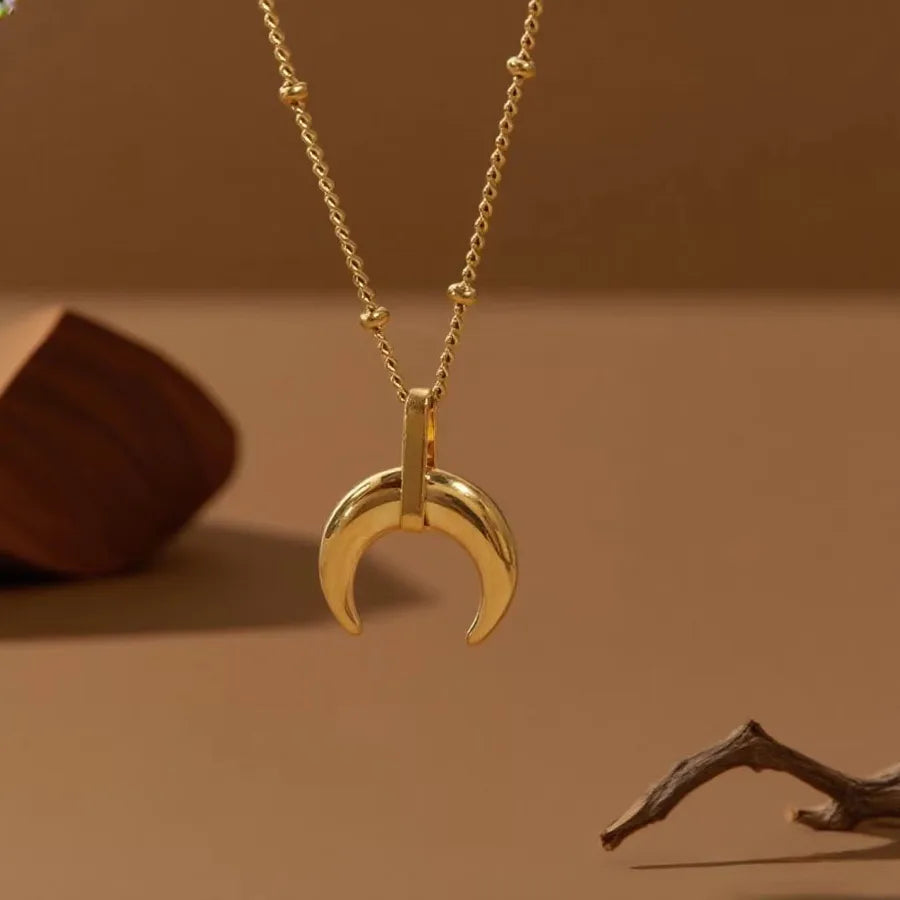 Gold-plated layered necklace with crescent moon pendant on beaded chain — minimalist celestial jewelry from The Layers.
