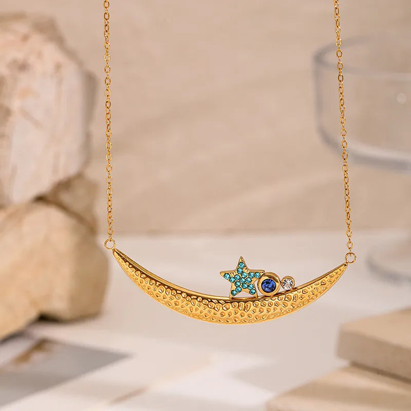 Set of gold-plated charm necklaces featuring moon, bow, gemstone, and enamel fish pendants — elegant handcrafted jewelry from The Layers.