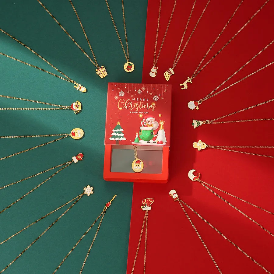 Flatlay of 24 Christmas-themed gold charm necklaces in a red and green advent-style gift box with Santa and festive packaging.