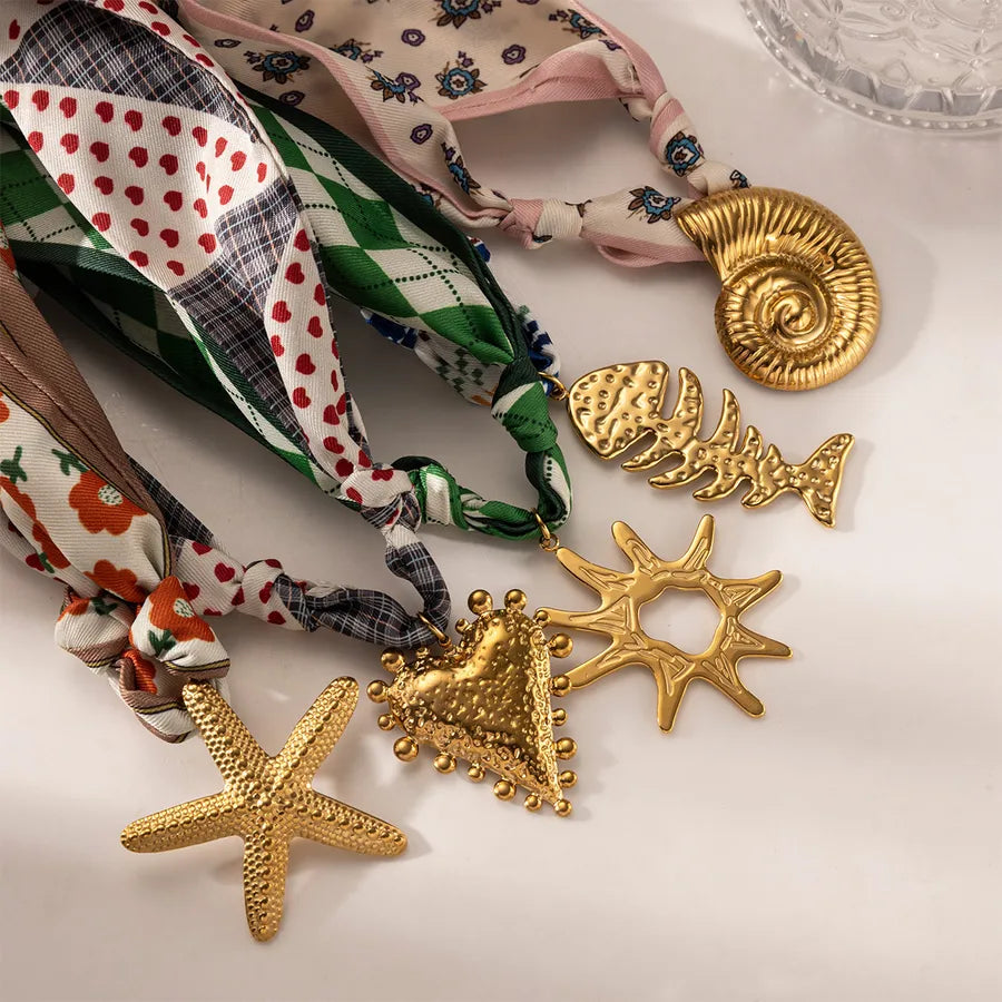 “Layers Store – Tide & Trinket coastal necklace collection with ocean-themed gold charms and printed scarf ties – UK jewellery dropshipping”