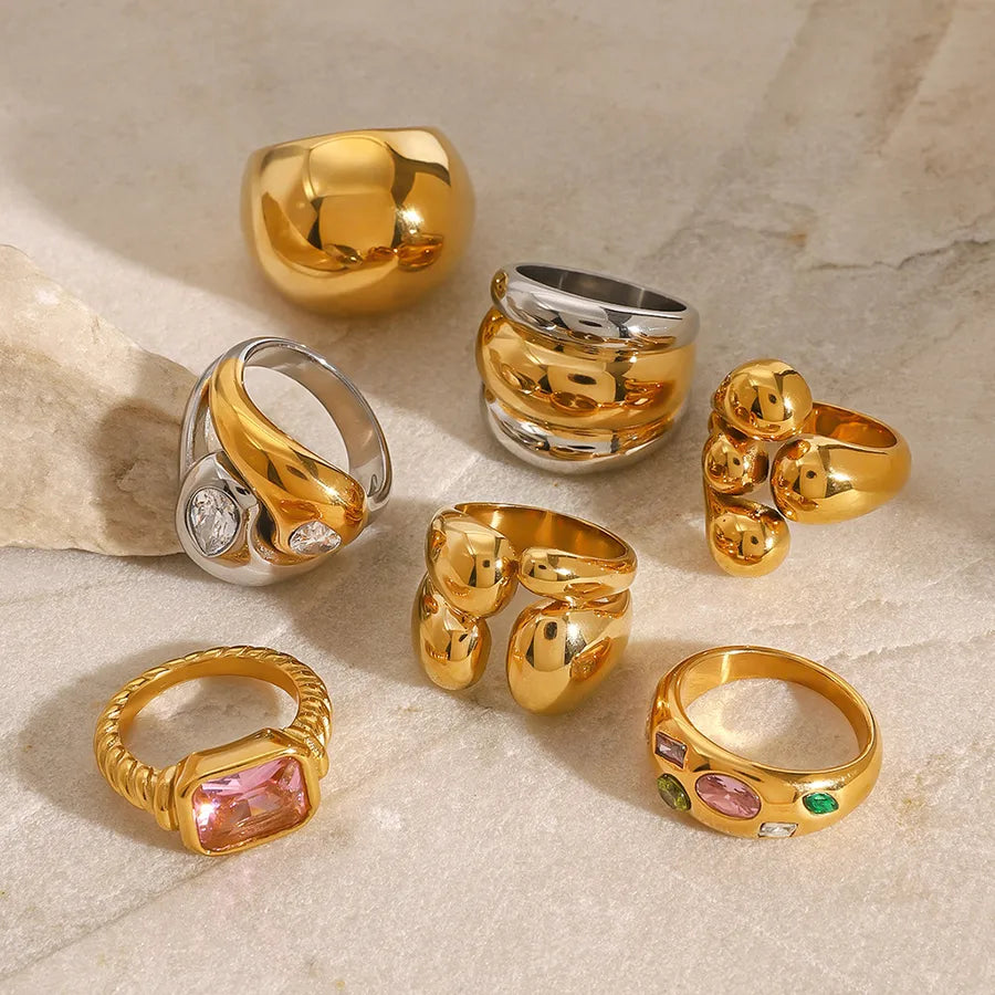Gold and silver chunky sculptural rings stacked on hands, featuring metallic finish from The Layers jewellery collection.
