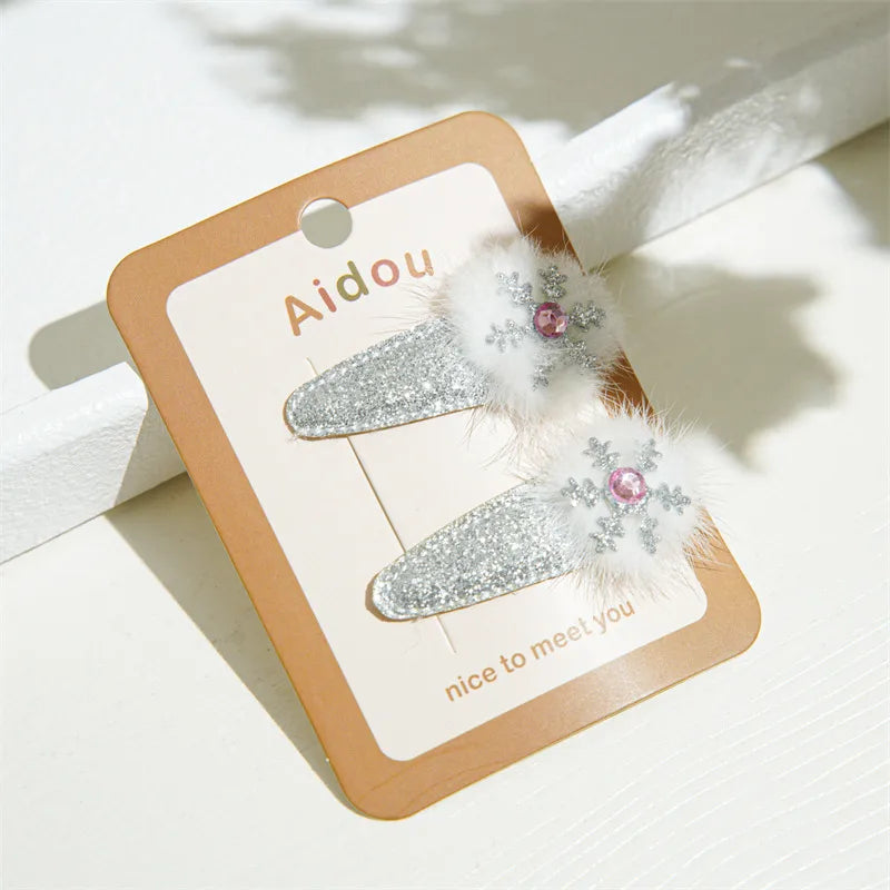 Festive Christmas-themed glitter hair clips featuring Santa, reindeer, Christmas trees, and gingerbread designs — perfect holiday accessories from The Layers.