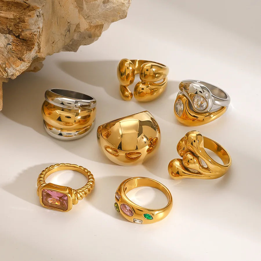 Gold and silver chunky sculptural rings stacked on hands, featuring metallic finish from The Layers jewellery collection.